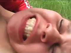 Young blonde sunbathing in a park is forced to sex